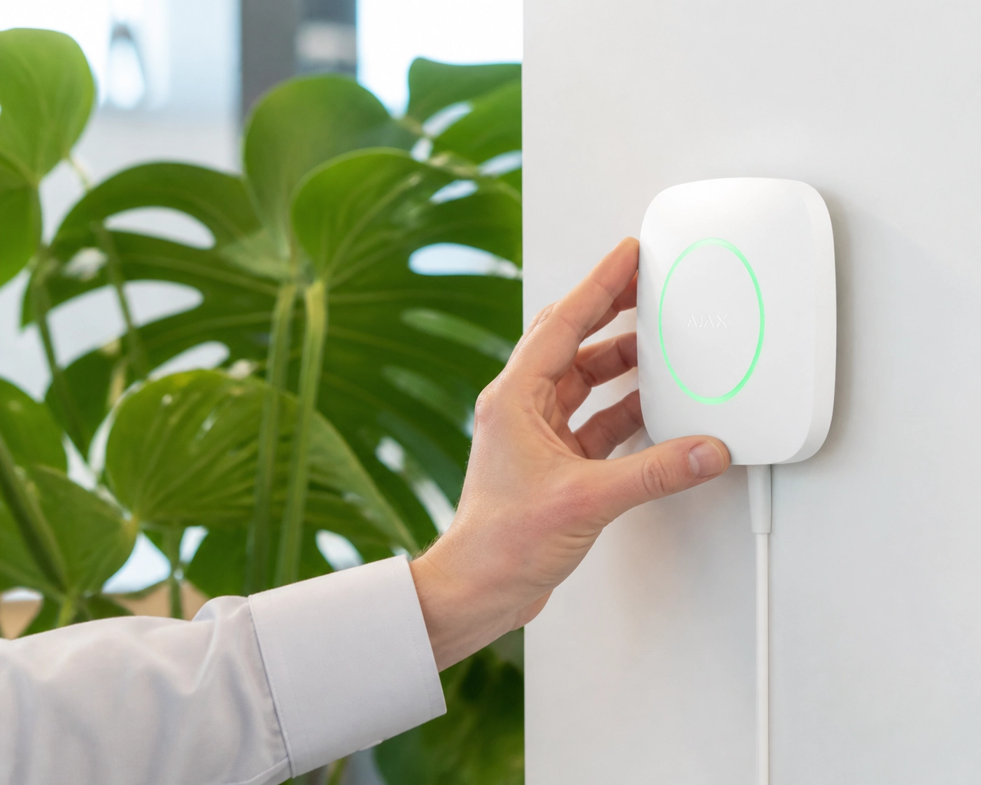 Person interacting with secure smart hardware representing managed website security and protection.