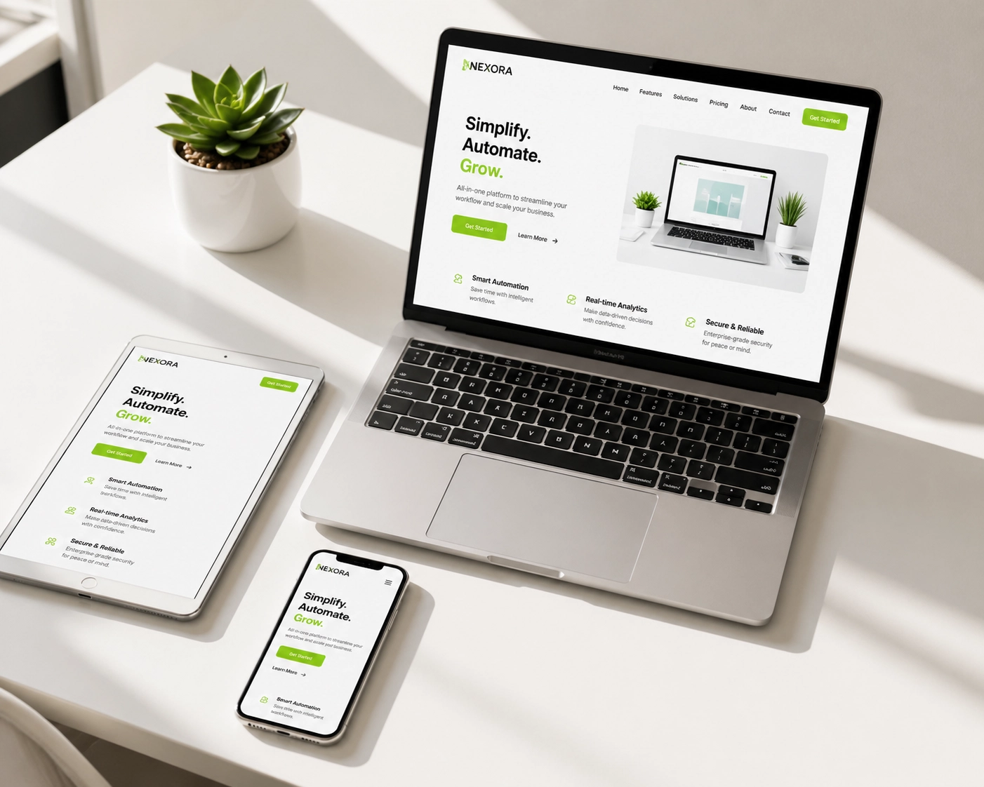 Responsive website design displayed across a laptop, tablet, and smartphone on a bright workspace.